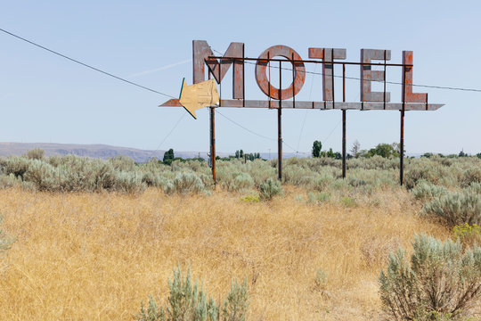 Vintage motel sign with dry scrub-land in foreground, Whitman County, Palouse, Washington, USA.