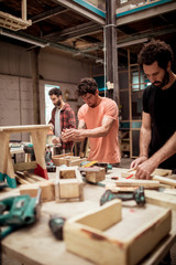Male carpenters working at workbench in workshop