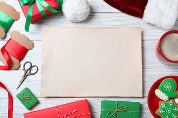 Flat lay composition with empty card and Christmas decorations on white wooden table, space for text. Writing letter to Santa Claus