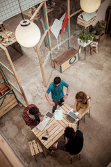 High angle view of craftsperson working at desk in office