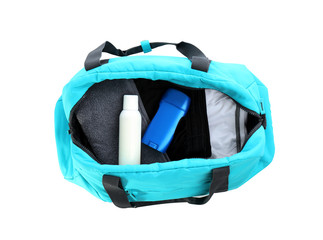 Sport bag with deodorants and clothes on white background, top view