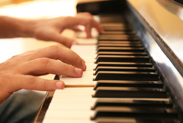 Obraz premium Man playing piano indoors, closeup. Music lesson