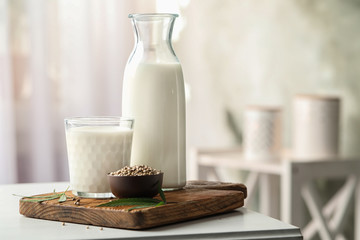 Composition with hemp milk on white table indoors