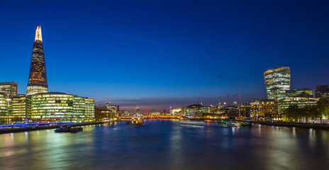 London Cityscape panorama at night, seen from Tower Bridge