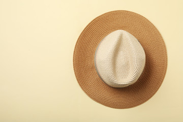Stylish hat on beige background, top view. Space for text