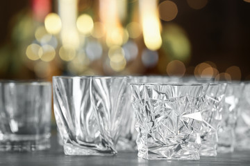 Empty glasses on table against blurred background