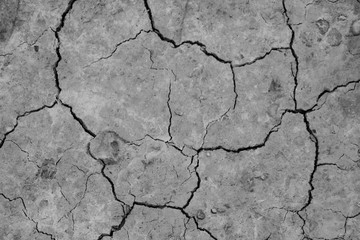 Close-up top view of a cracked part of the earth from a mud volcano, background, out of focus, blank for designers, selective focus.