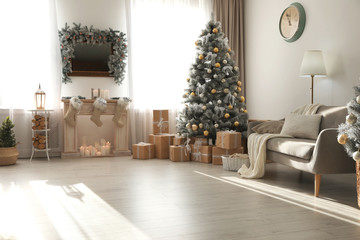 Obraz na płótnie Canvas Stylish Christmas interior with beautiful decorated tree and fireplace
