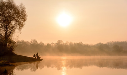 Morning fog on the river. Fishermen at dawn. Autumn