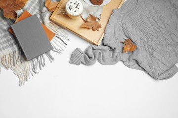Fototapeta na wymiar Flat lay composition with soft knitted sweater on white background