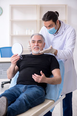 Old man visiting young doctor for plastic surgery