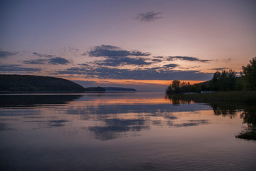 Picturesque dramatic scene. Beauty in the world. instagram effect. Retro vintage style..Majestic sunset over the lake. Overcast clouds in the sky..