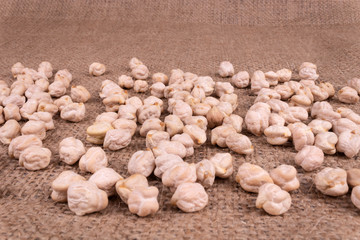 on burlap, dense fabric, dark brown lay the seeds of ram chickpea dry