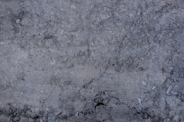 White and grey granite, limestone, or travertine surface with random black organic natural deep bumpy scratch pattern on surface.