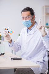 Young male chemist working in the lab