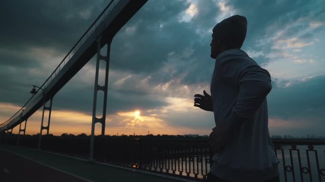 guy runs in the city in cloudy weather