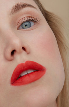 Woman's face with made up red lips, close-up