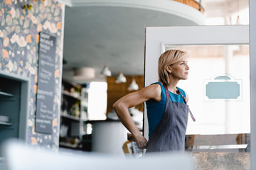 Young business owner opening her coffee shop