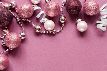 Lilac christmas background with christmas balls and festive. Flat lay