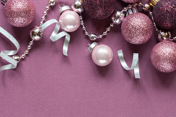 Lilac christmas background with christmas balls and festive. Flat lay