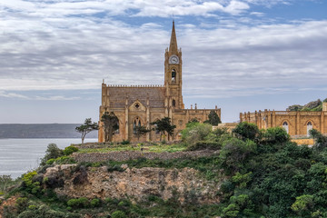 Fototapeta na wymiar View of Our Lady of Lourdes church on hill, Mgarr, Goza island, Malta