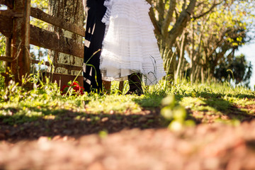  Bride putting on boots with her groom in rustic place.