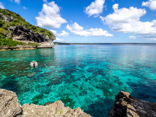 Small boat in blue waters of a bay