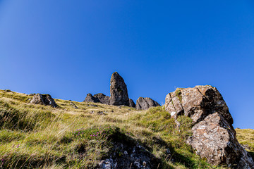 The Old Man of Storr on the Isle of Skye, with a blue sky overhead