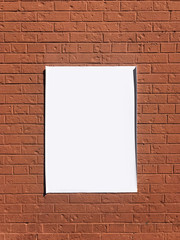 empty poster on brick wall