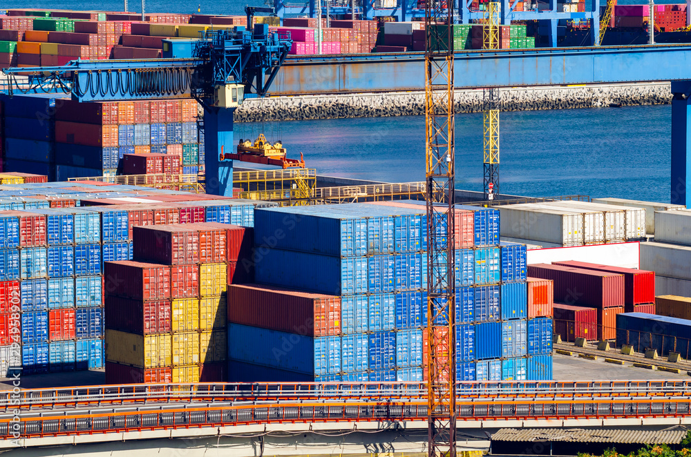 Wall mural stacked cargo containers in storage area of freight sea port