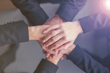 Obraz premium Creative team putting their hands together in circle