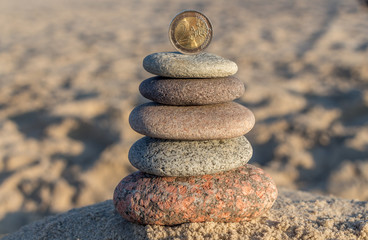 2 EUR coin and pebble