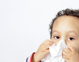 child blowing nose after catching a cold with white background stock photo 
