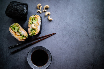 Curry onigirazu with organic vegetables and soy sauce on a plate. Japanese food.