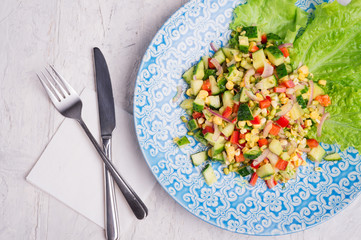 Hawaii style vegetarian raw eating salad. served in beauiful blue plate on white table. flat lay. close up