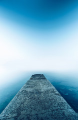 Perspective Cement pier with beautiful sea nature background. Abstract long exposure photography gradient wallpaper advertise. Concept desktop relax