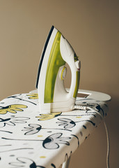 Closeup of woman ironing clothes on ironing board. Housework concept