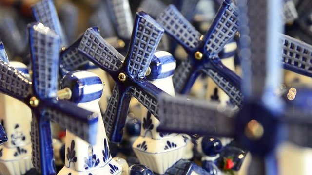 Delft, Holland, August 2019. Close-up image of small ceramic windmills in a tourist shop. Symbol of the Netherlands, the windmill is proposed as a souvenir.