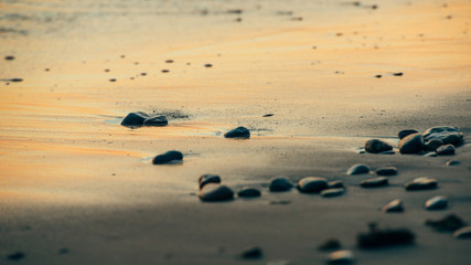 Small sea rocks in the sand