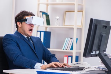 Employee using virtual reality glasses in office