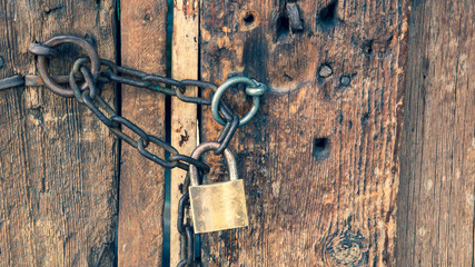 wooden old house door and padlock on