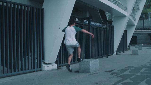 the guy is doing parkour at the stadium