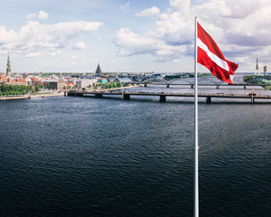 Panoramic view of Riga and Latvian flag in foreground. 