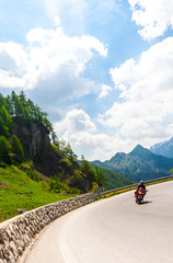 Motorcyclists on mountain bend road pass, Dolomites, Italy.