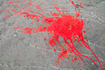 Neon pink blot, vivid paint splash on a rock surface.