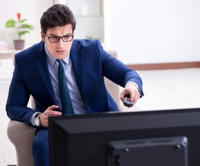 Fototapeta premium Businessman watching tv in the office
