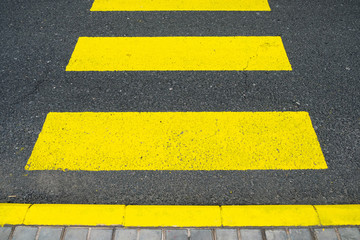 Fototapeta premium Yellow zebra crossing bands painted on the road.