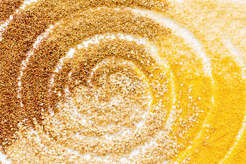Cereals - rice, oats, buckwheat - background with drawn spiral top view copy space