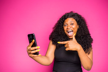 a young Nigerian lady feels happy with what she saw on her phone
