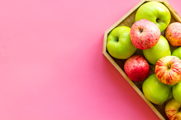 Healthy diet concept. Fresh apples in tray on pink background top view space for text